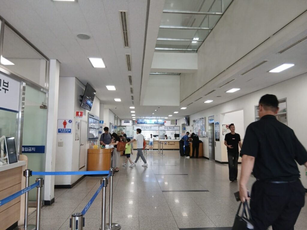 국적회복 신청 접수를 위해 방문한 출입국외국인관서 민원실 내부 전경과 대기하는 사람들로 많은 재외동포들이 방문한 출입국 관리소 내부의 모습을 담고 있습니다.